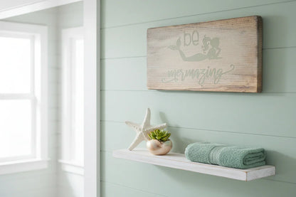 Be mermazing driftwood sign displayed in coastal bathroom with starfish succulent and seafoam green accents