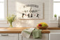 In This Kitchen We Dance sign styled in bright farmhouse kitchen with wildflowers and linen towels